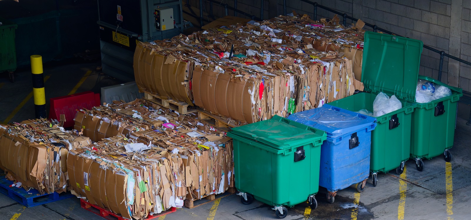 Cardboard and rubbish in waste compound for disposal at dump site